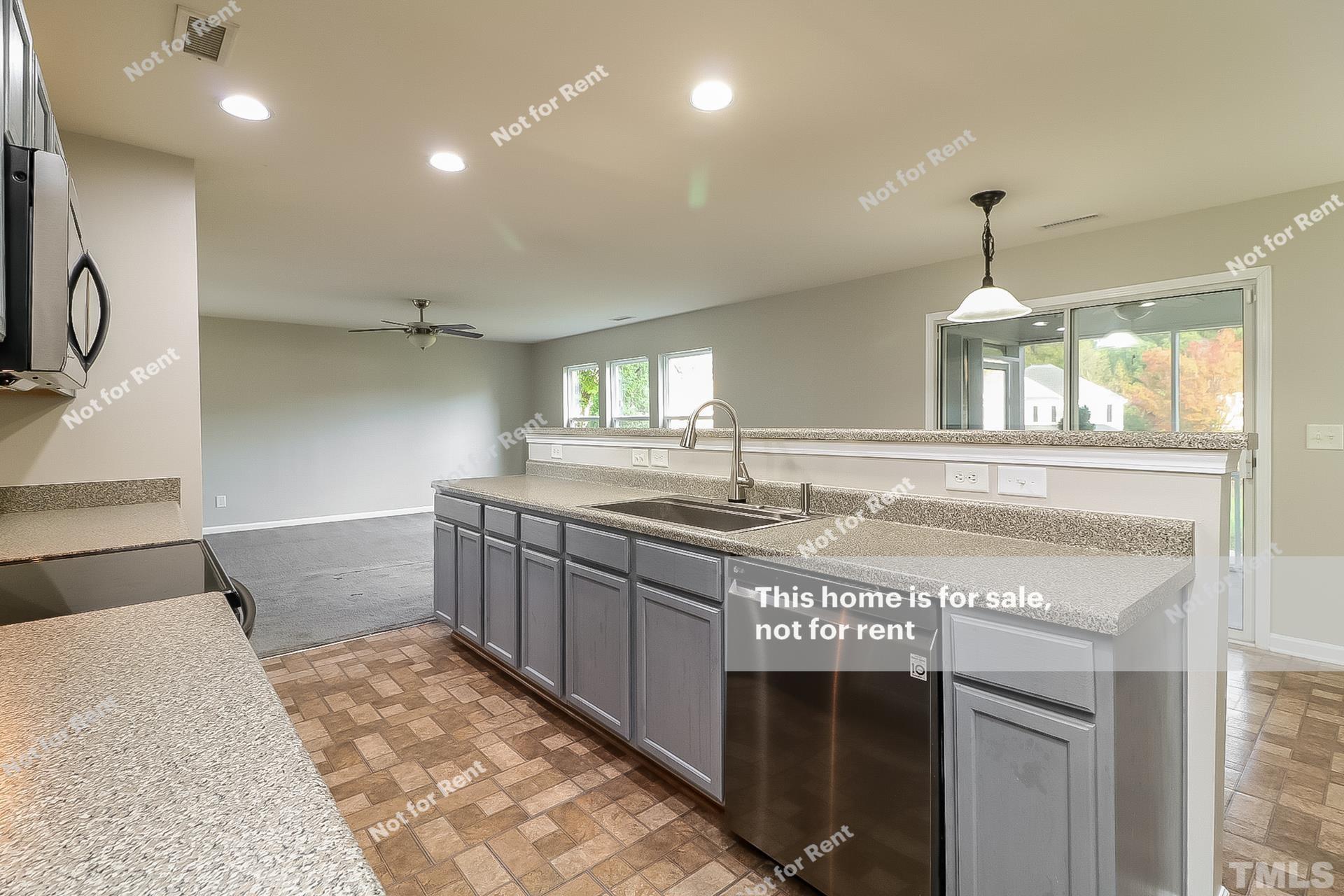 115 Cinder Cross Way Garner, NC 27529 - Photo 8 of 27 a kitchen with kitchen island granite countertop a stove and a sink