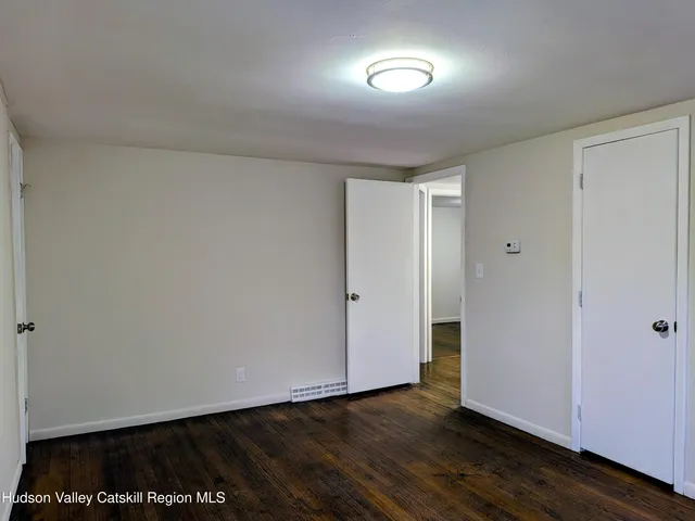 a view of an empty room and wooden floor