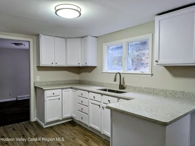 a kitchen with stainless steel appliances granite countertop a sink stove and cabinets