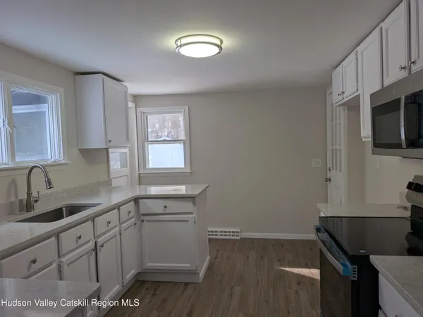 a kitchen with sink cabinets and appliances