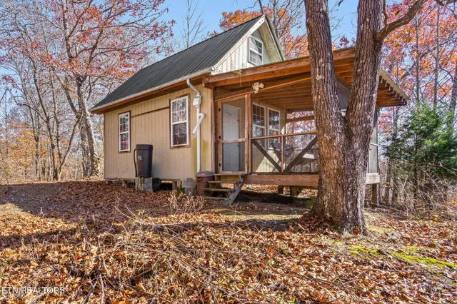 a backyard of a house with barbeque oven and table