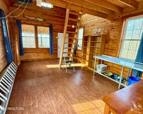 a view of a living room with wooden floor