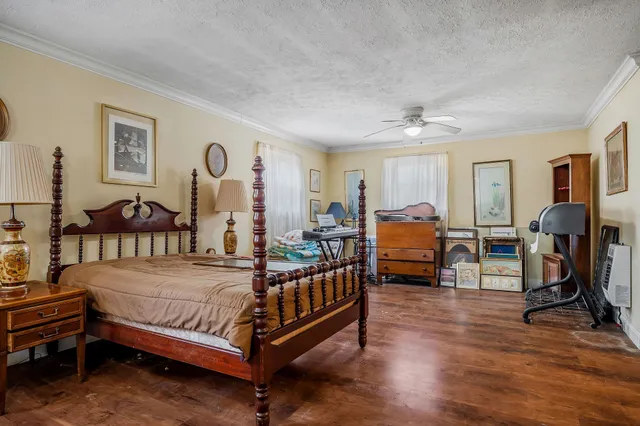 a bedroom with bed and glass door