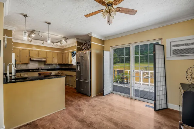 a kitchen with stainless steel appliances granite countertop a stove and a refrigerator