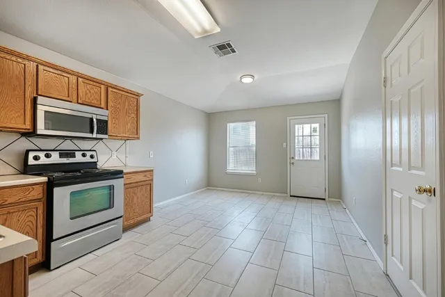 a view of a kitchen with an oven and cabinets