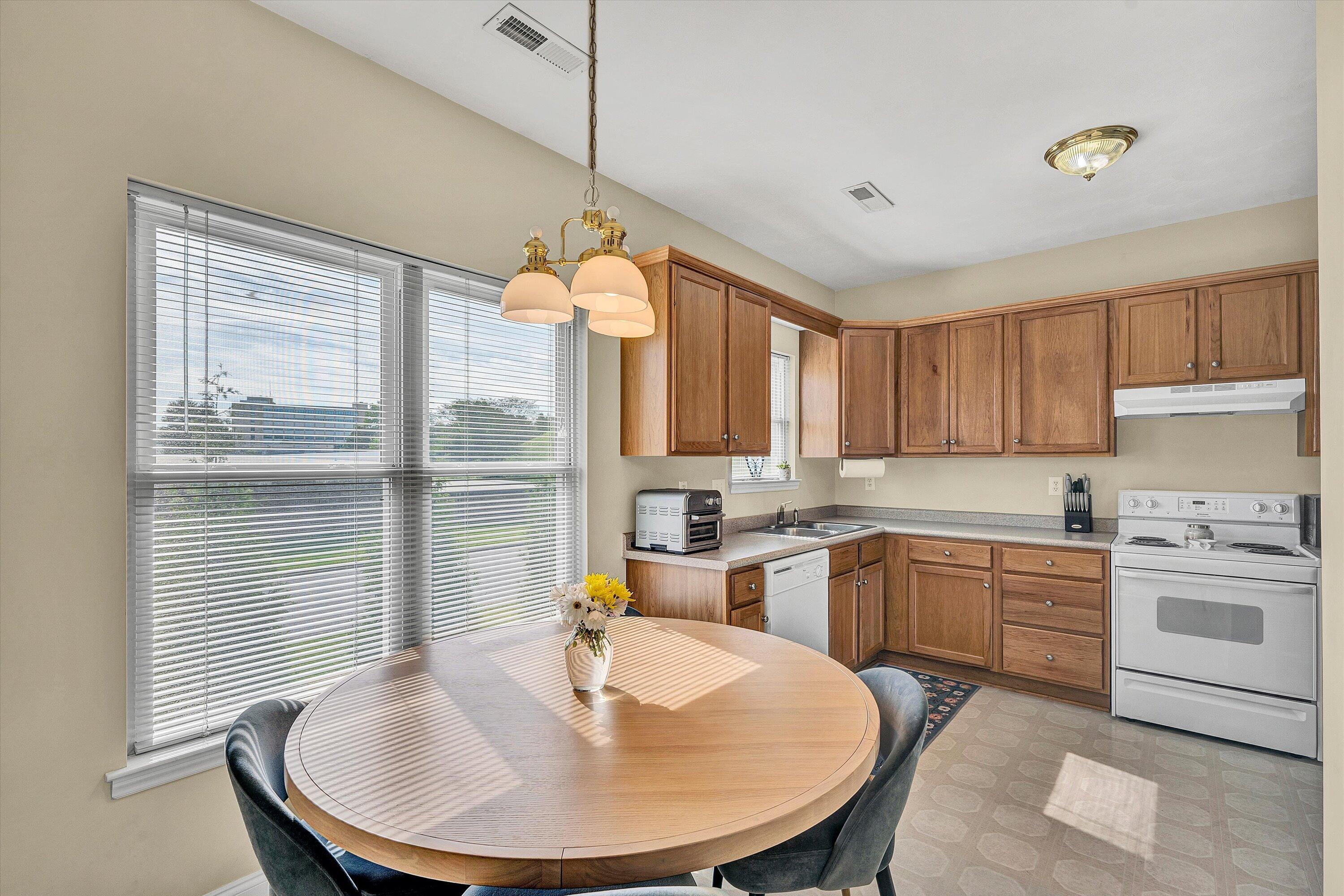 1913 South Clearing Road Salem, VA 24153 - Photo 15 of 28 a kitchen with a table chairs sink and cabinets