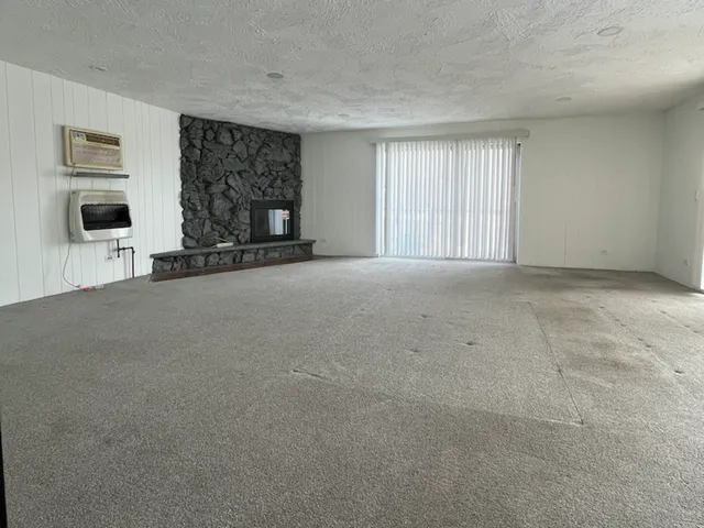 a view of a livingroom with furniture and a window