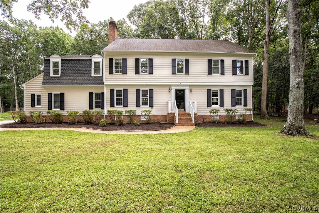 14211 Helmsley Road Midlothian, VA 23113 - Photo 3 of 47 a front view of a house with garden and trees