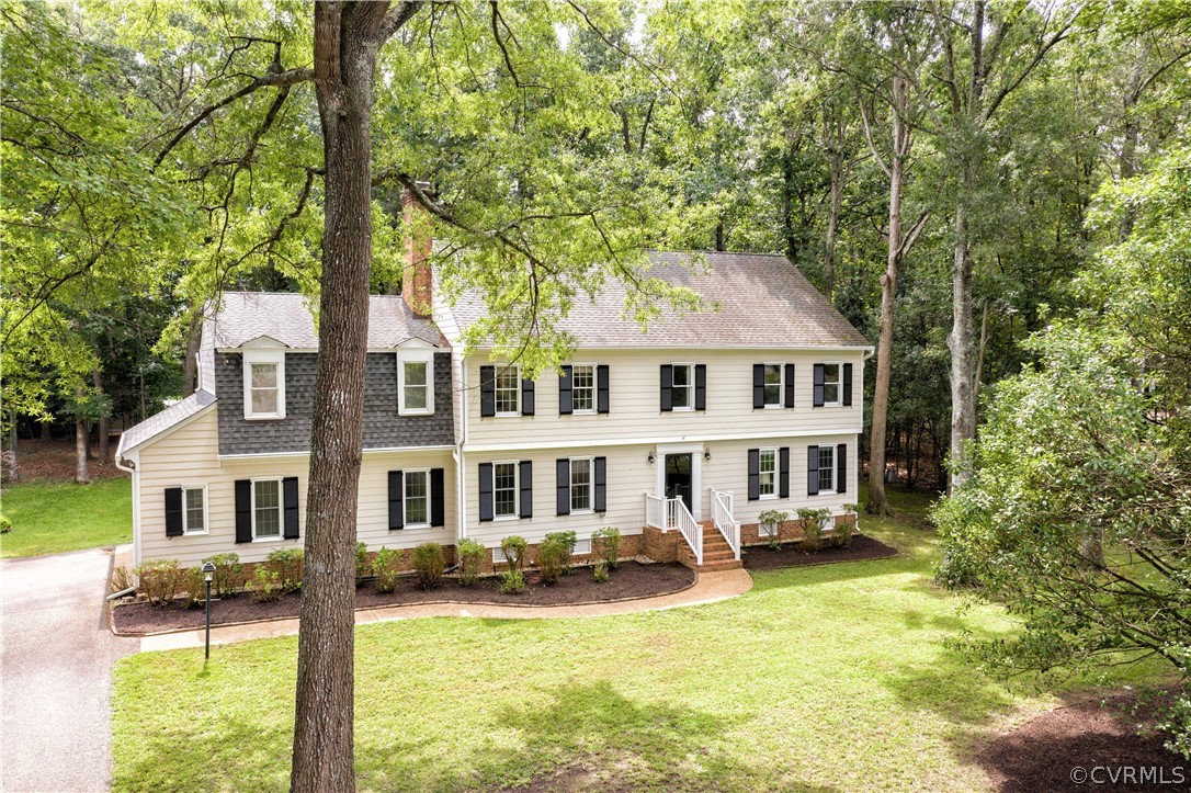 14211 Helmsley Road Midlothian, VA 23113 - Photo 46 of 47 a front view of a house with a yard table and chairs