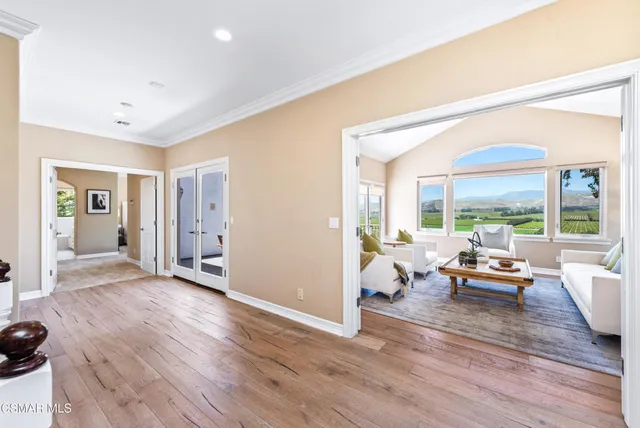 a living room with furniture a fireplace and a large window