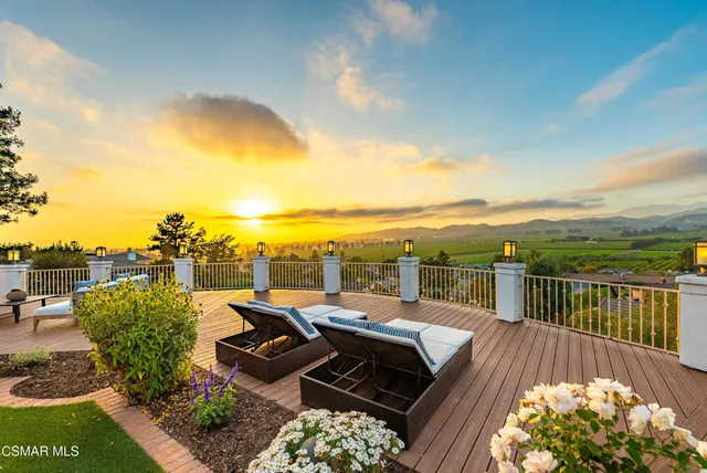 a view of a roof deck with table and chairs