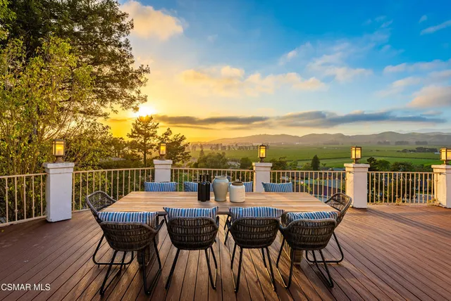 a view of a patio with couches chairs and a big yard