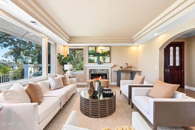 a living room with fireplace furniture and a wooden floor