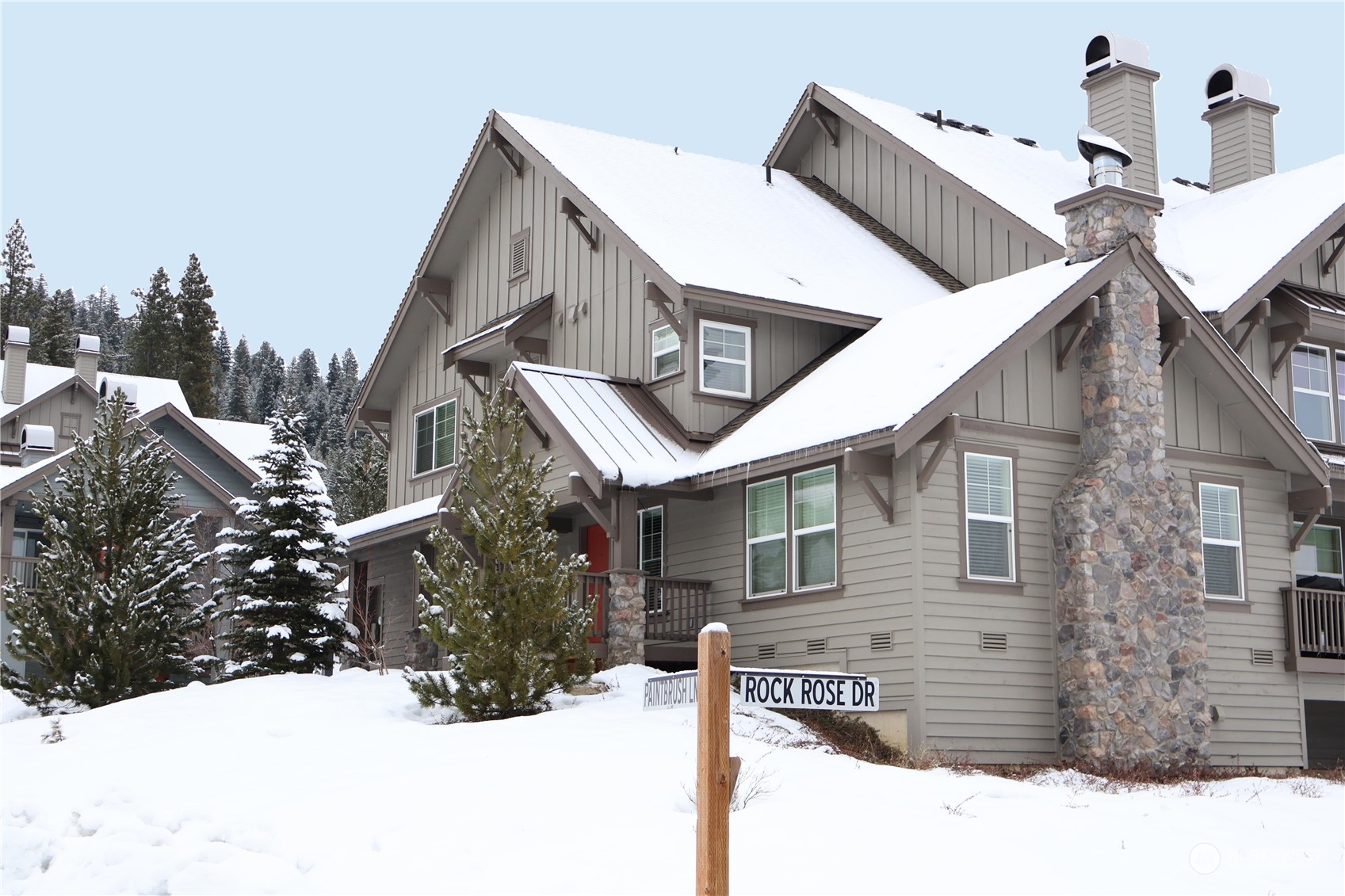 a view of a house with a yard covered in snow