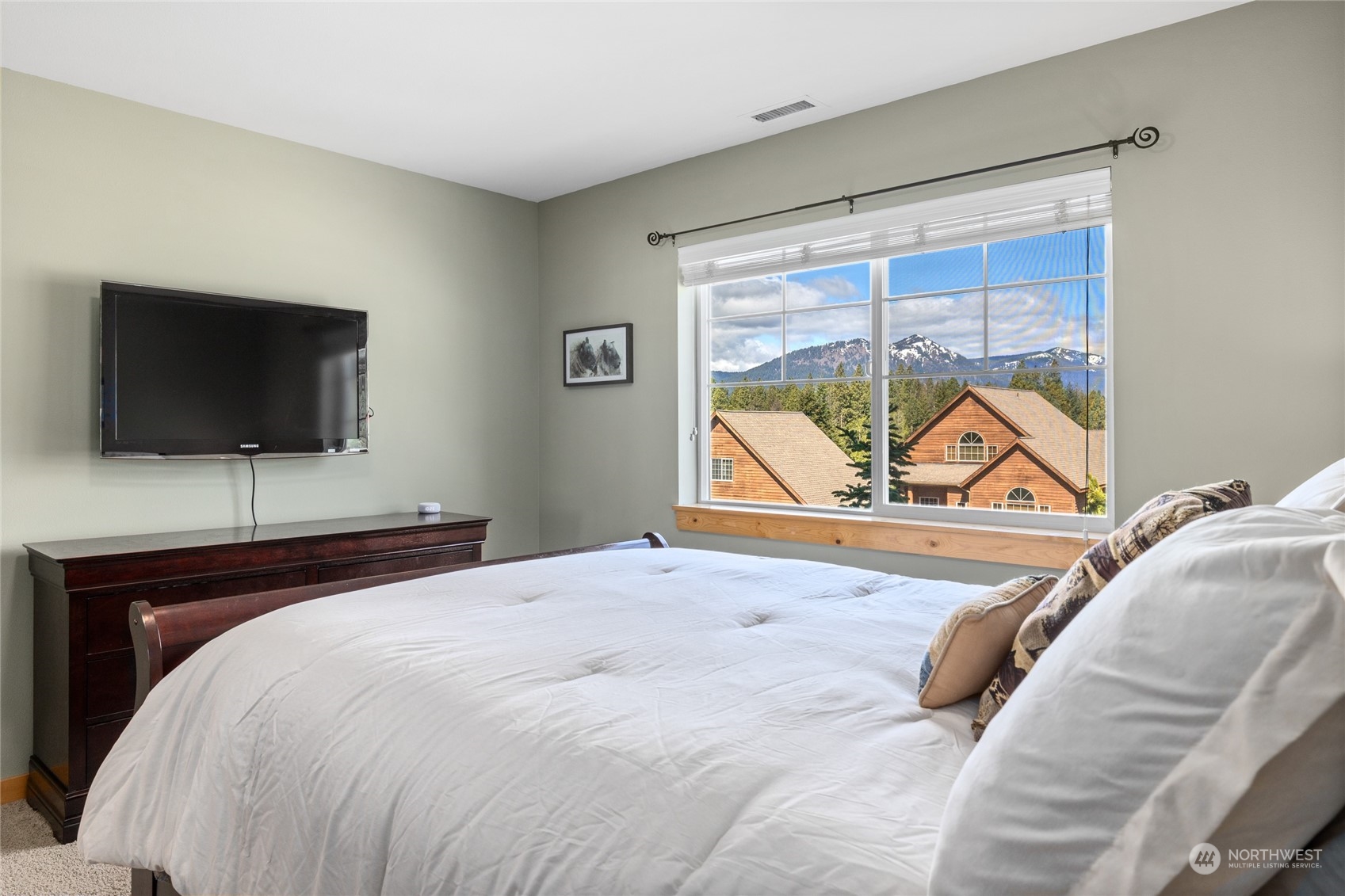 50 Raintree Lane, Unit 4 Ronald, WA 98940 - Photo 16 of 28 a bedroom with a bed and a flat tv screen next to a window