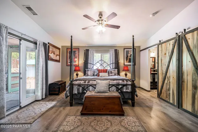 a bedroom with a bed and a flat tv screen