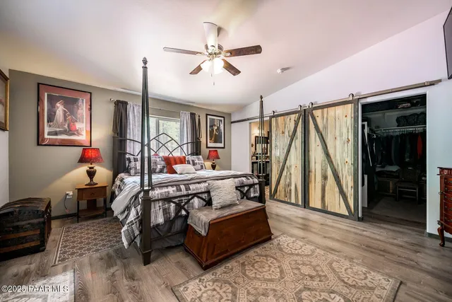 a view of walk in closet with clothes