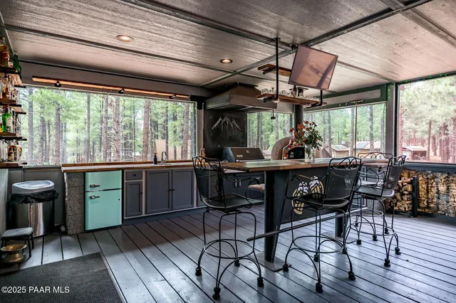 a backyard of a house with barbeque oven and trees