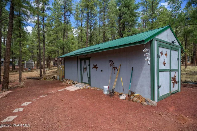 a front view of a house with a garden and trees
