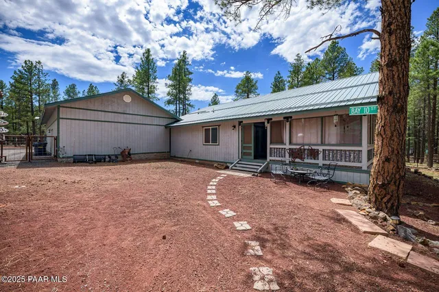 a view of a house with a yard and tree