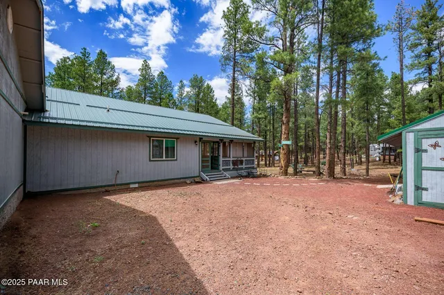 a view of a house with a yard and tree
