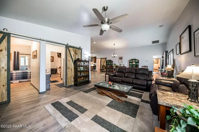 a living room with furniture and wooden floor