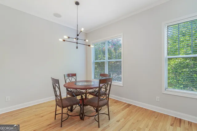 a view of a dining room with furniture and wooden floor