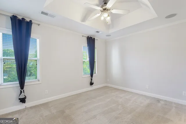 an empty room with closet and a chandelier fan