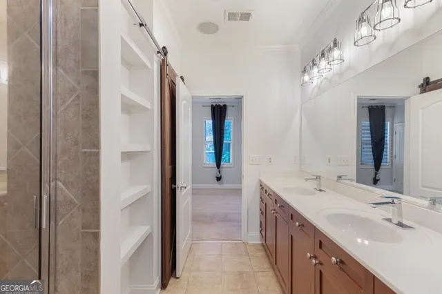 a bathroom with a glass shower door and a sink
