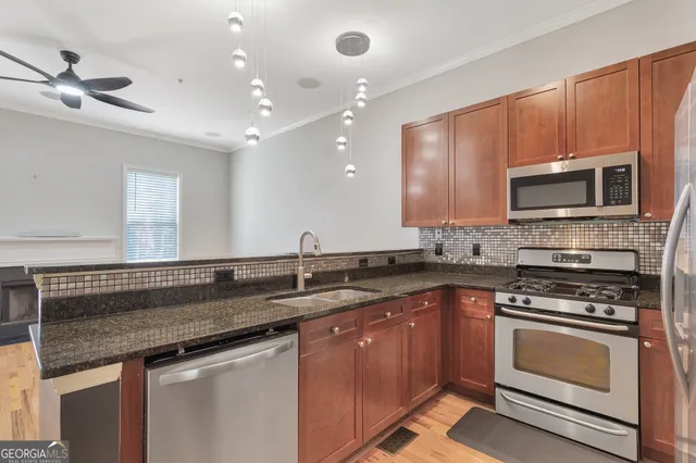 a kitchen with a sink stove and microwave