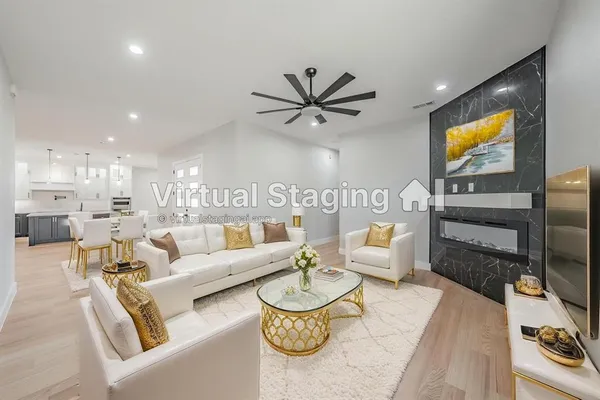 a living room with furniture a rug and a flat screen tv