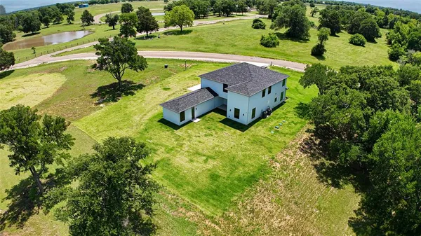 an aerial view of a house with yard swimming pool and outdoor seating
