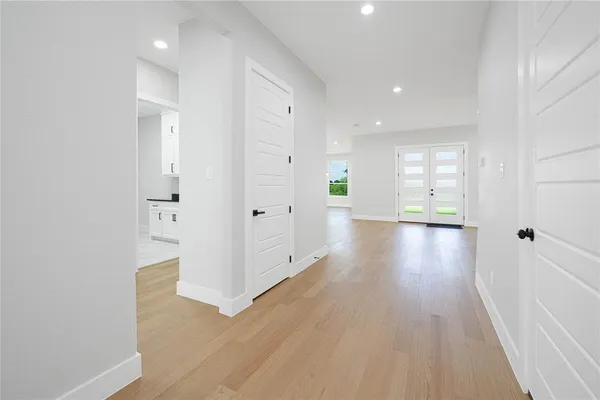 a view of a hallway with wooden floor