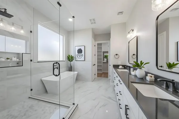 a large bathroom with a double vanity sink a mirror and shower