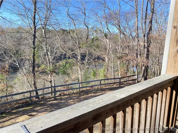 a view of a wooden bench next to a road