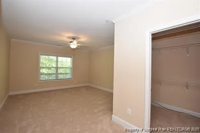 a view of a livingroom with a ceiling fan and window