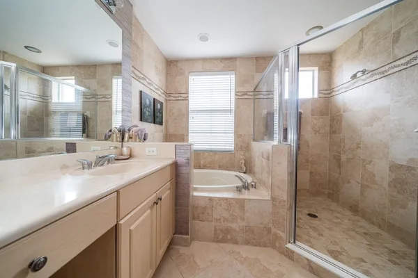 a bathroom with a double vanity sink toilet and shower