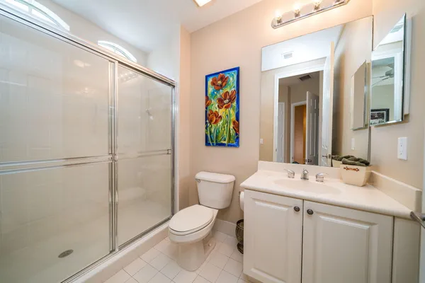a bathroom with a toilet a sink and a mirror