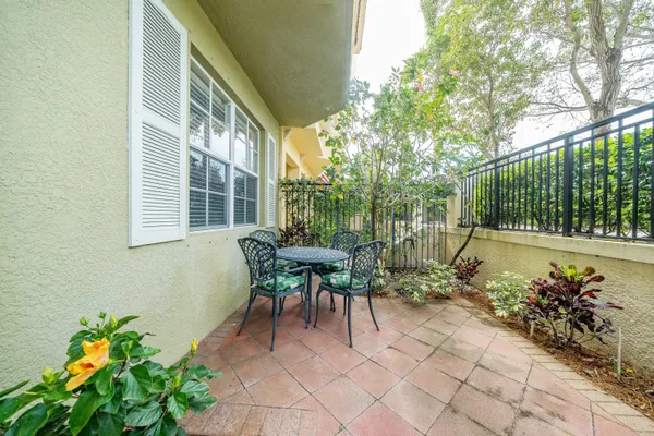 a view of a patio with table and chairs and potted plants