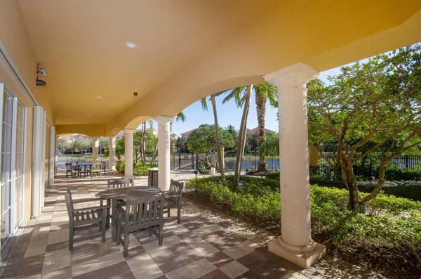 a view of a patio with table and chairs and potted plants