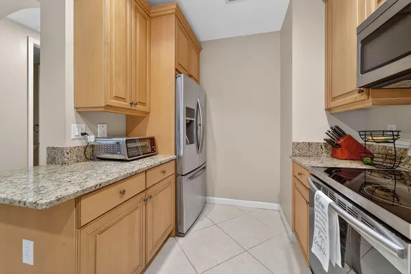 a kitchen with stainless steel appliances granite countertop a stove and a refrigerator