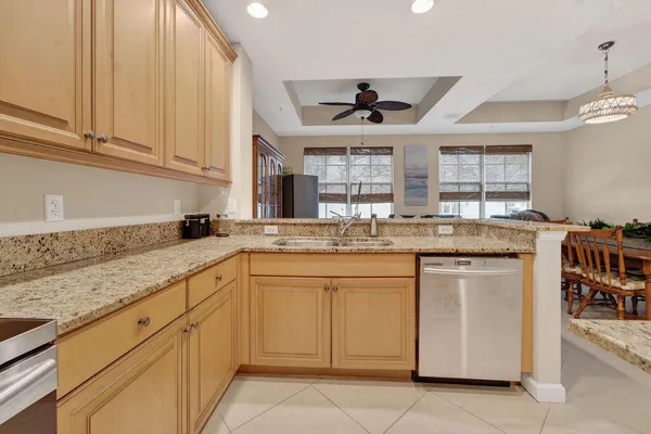a kitchen with stainless steel appliances granite countertop a sink and cabinets