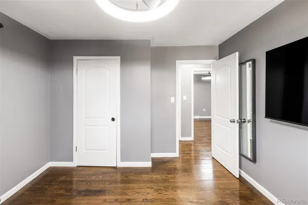 a view of a hallway with wooden floor