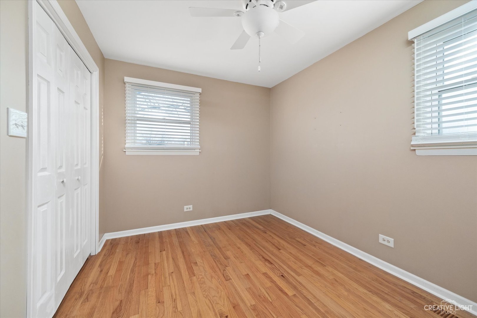1925 Briarcliffe Boulevard Wheaton, IL 60189 - Photo 12 of 21 wooden floor in an empty room with a window