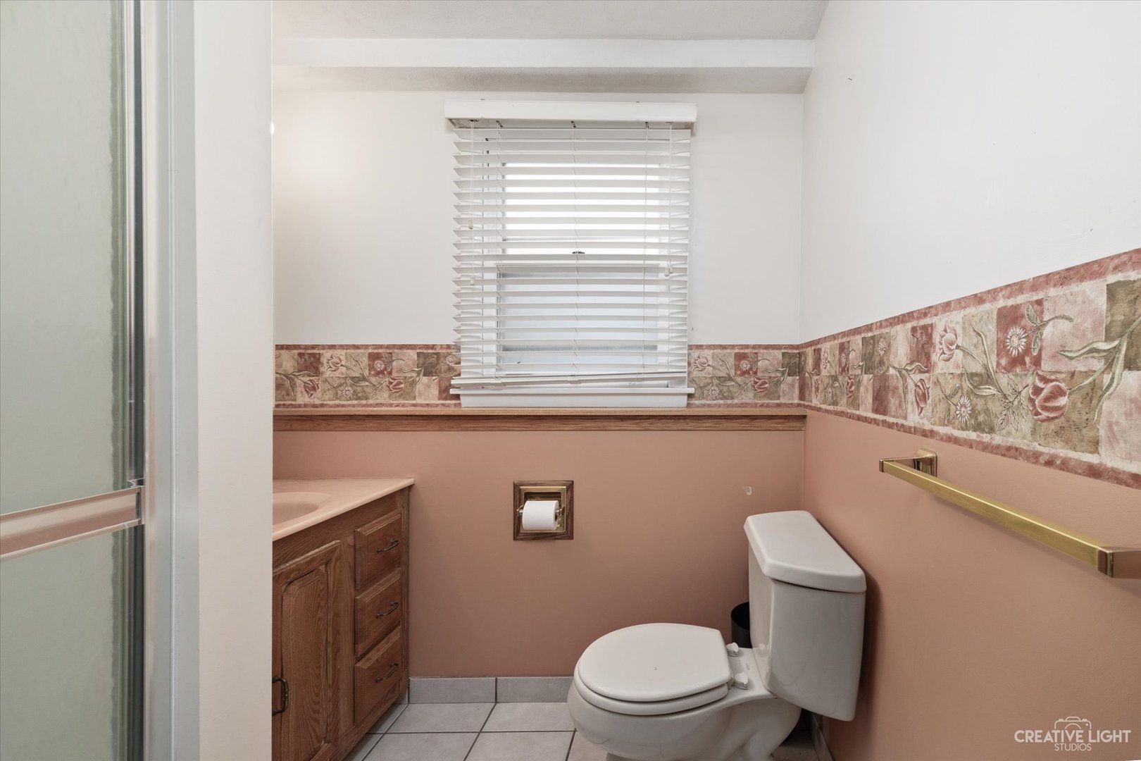 1925 Briarcliffe Boulevard Wheaton, IL 60189 - Photo 19 of 21 a bathroom with a toilet a sink and a window
