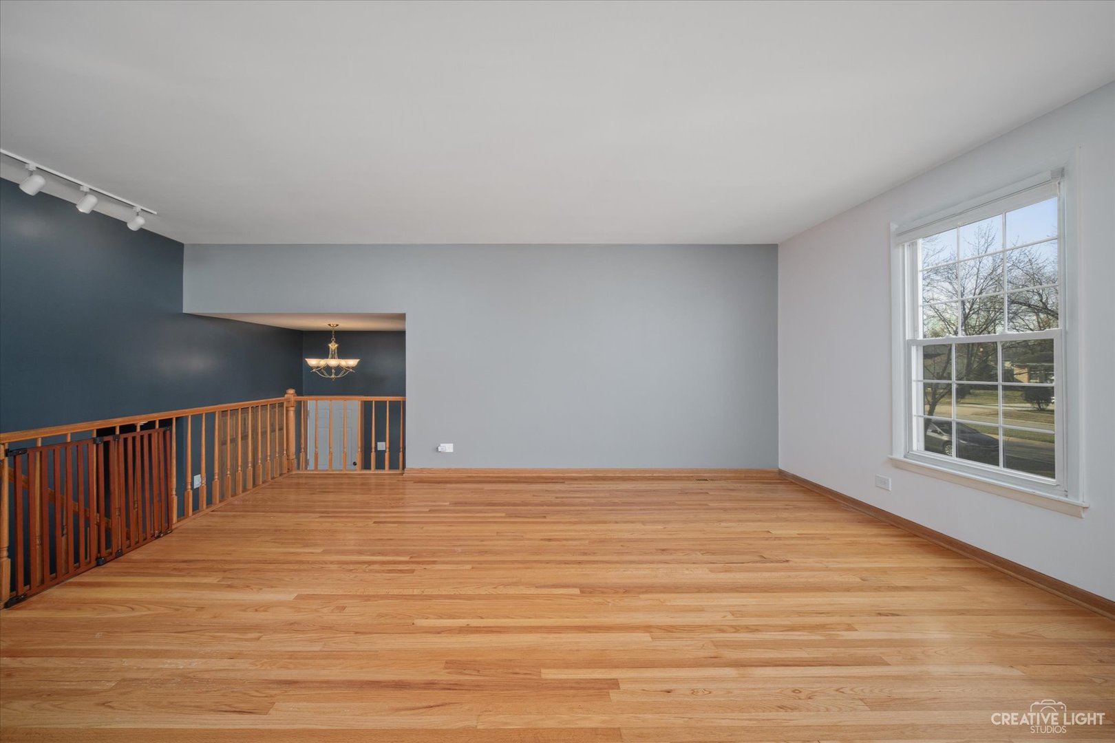 1925 Briarcliffe Boulevard Wheaton, IL 60189 - Photo 3 of 21 a view of an empty room with wooden floor and a window