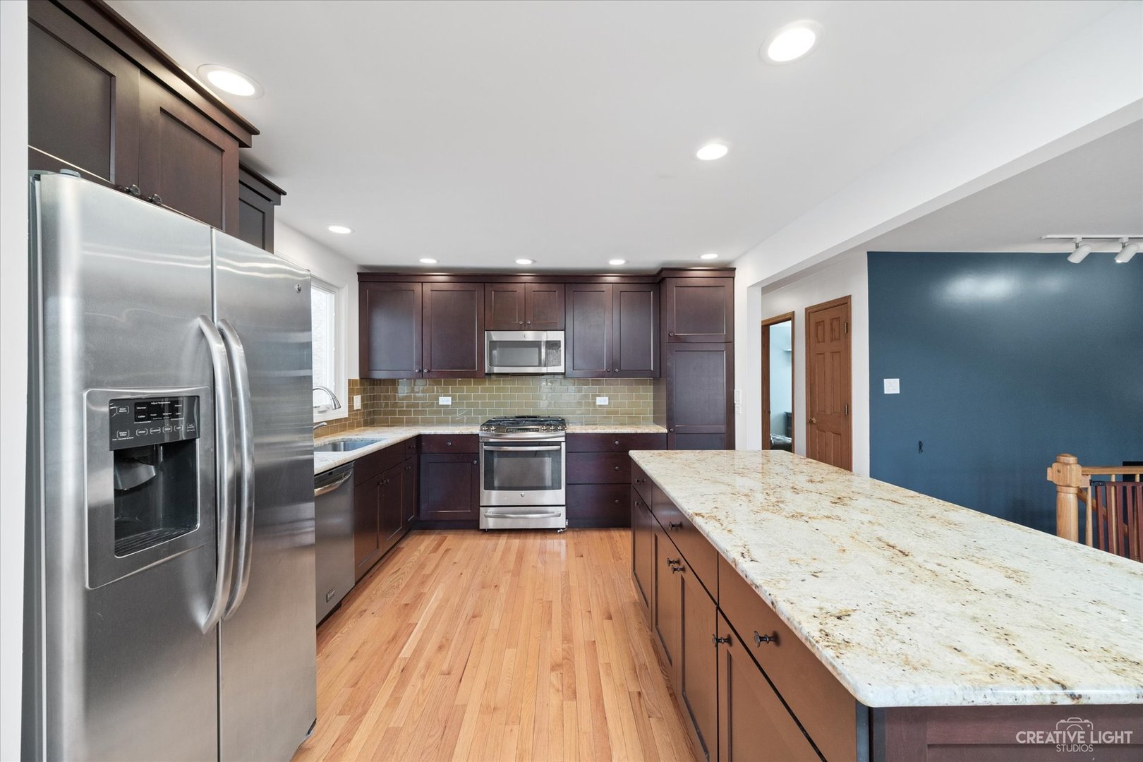 1925 Briarcliffe Boulevard Wheaton, IL 60189 - Photo 5 of 21 a large kitchen with a large counter top stainless steel appliances and cabinets