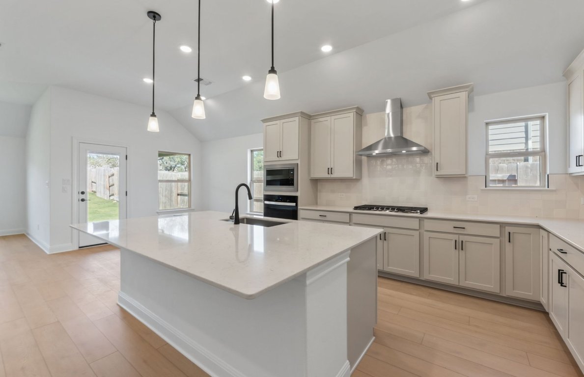 800 Crescent View Drive Georgetown, TX 78628 - Photo 20 of 36 a large kitchen with stainless steel appliances a large center island attached withe living room