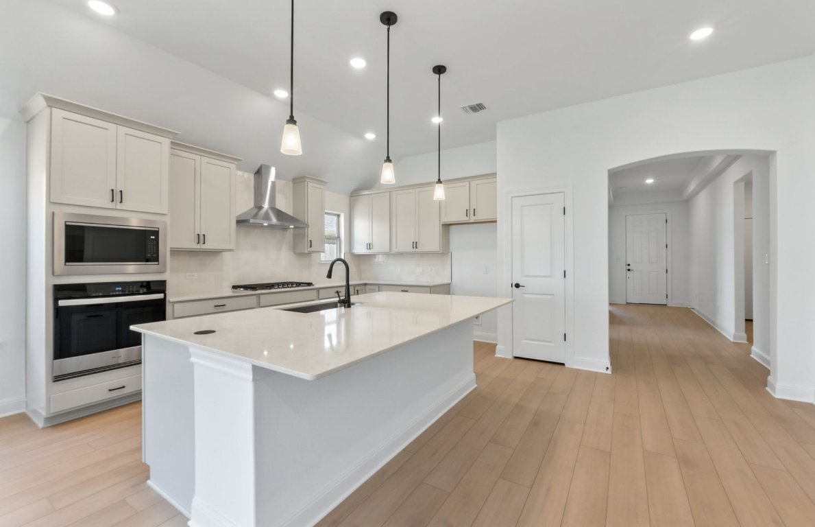 800 Crescent View Drive Georgetown, TX 78628 - Photo 21 of 36 a large kitchen with stainless steel appliances a large counter top a stove a sink and a refrigerator