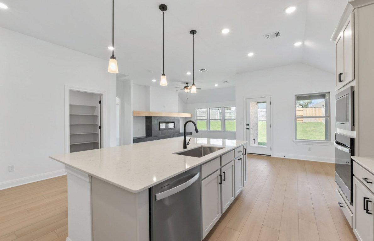 800 Crescent View Drive Georgetown, TX 78628 - Photo 23 of 36 a kitchen with a sink center island and windows